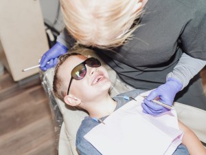 Child wearing sunglasses during dental checkup