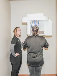 Staff operating 3D dental scanner for patient imaging